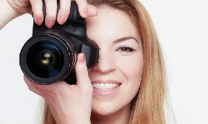 Woman holding a camera and taking pictures - Best cheap digital camera under $50