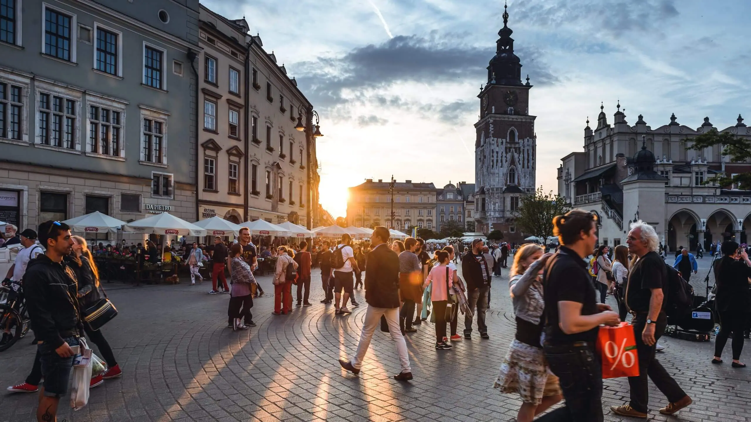 people waling in the evening sun in a European market