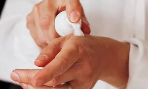 Woman using hand lotion- Can I bring hand lotion on a plane?