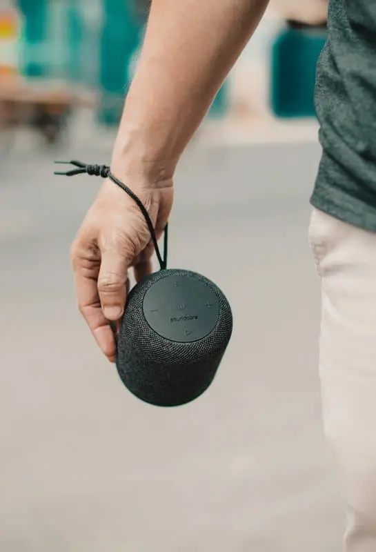 Man Holding Bluetooth Speaker