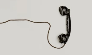 an old vintage phone and phone cord - What color paint is used on all public phone booths and mailboxes in England