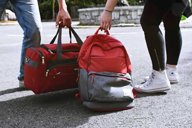 Women picking up luggage - can I bring a lighter on a plane?